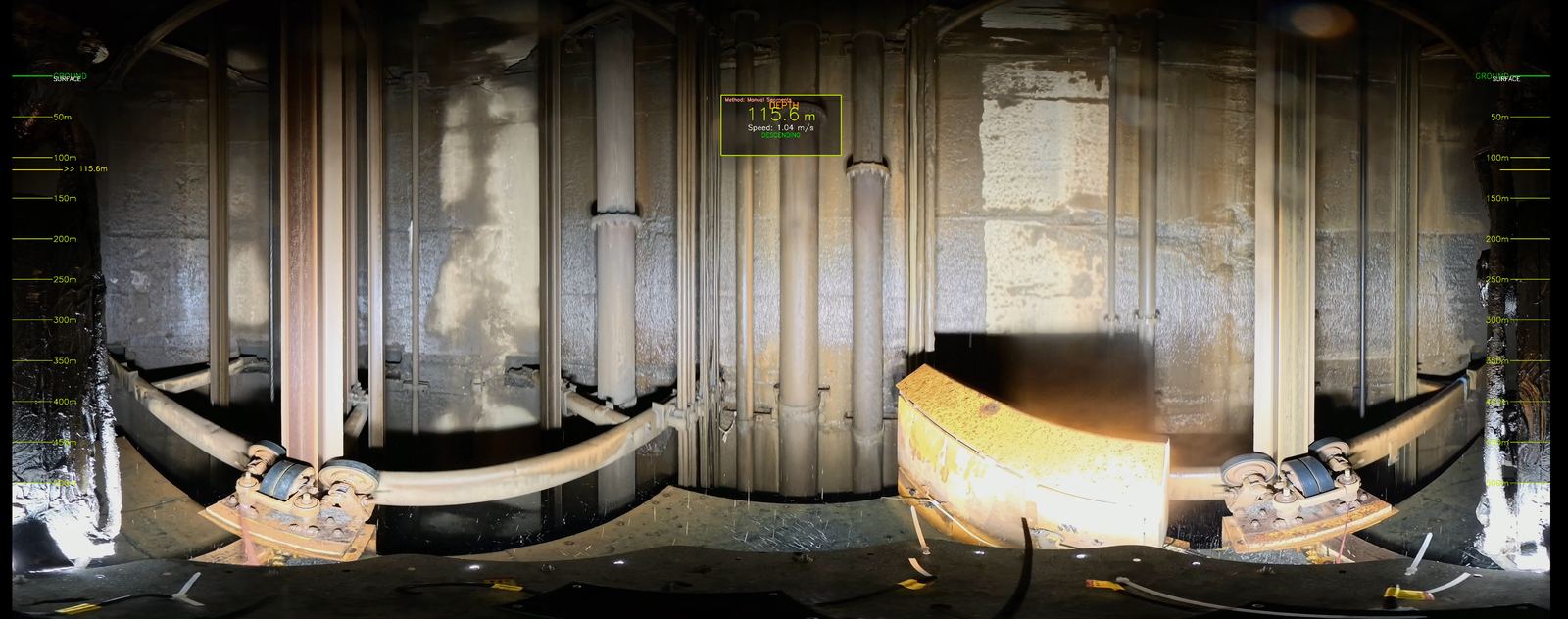 An unwrapped cylindrical projection of a mine shaft wall captured by the Delta Scan shaft scanner, with a depth register down each side and a live scan readout showing depth and descent speed